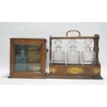 Oak three-section tantalus with decanters and an oak and glazed cabinet enclosing decanter, with