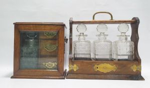 Oak three-section tantalus with decanters and an oak and glazed cabinet enclosing decanter, with