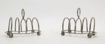Pair of George V silver four section toast racks, raised on ball feet (S W Smith and Co, Birmingham,