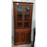 20th century mahogany corner display cabinet, two glazed doors enclosing three shelves all on a base