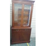 20th century mahogany display cabinet with two glazed doors above two drawers and two cupboard