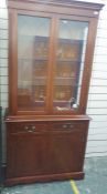20th century mahogany display cabinet with two glazed doors above two drawers and two cupboard