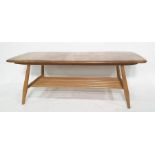 Light elm Ercol oblong coffee table on beech supports and spindle undertier, 105cm x 36cm