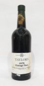 Bottle of Taylors 1975 vintage port, label complete and wax capsule top is present