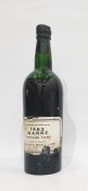 One bottle of Warre's port 1963 vintage port. Label is complete but damaged, wax capsule is