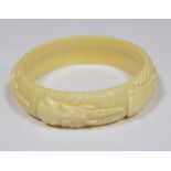 Carved ivory-coloured bangle embossed elephant masks