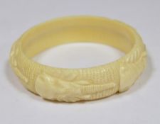 Carved ivory-coloured bangle embossed elephant masks