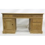 Modern oak desk, the rectangular top with moulded edge, assorted drawers and cupboard doors, the