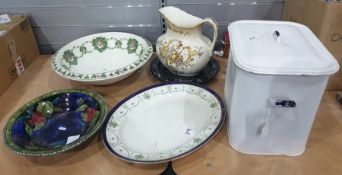 White enamel breadbin containing jelly moulds, ceramic dishes, meat platter, two large bowls,