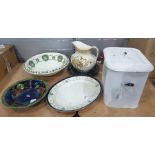 White enamel breadbin containing jelly moulds, ceramic dishes, meat platter, two large bowls,
