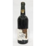 Bottle of Taylors 1975 vintage port, label is present but damaged, wax capsule top is present but