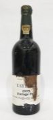 Bottle of Taylors 1975 vintage port, label is present but damaged, wax capsule top is present but