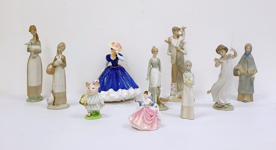 Collection of ten various porcelain figurines to include a Lladro figure of boy holding goat, a