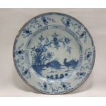 Antique delft-style ceramic plate painted in underglaze blue in the Chinese manner with cockerels