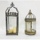 Two garden lanterns for candles, one with glass domed top and cylindical body, one square