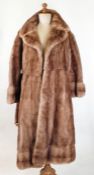 1970's full-length mink coat, the hem banded, cuff sleeves, with belt and metal buckle