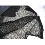 Length of black net embroidered with bugle beads, a devore black velvet shawl and another and a grey
