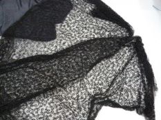 Length of black net embroidered with bugle beads, a devore black velvet shawl and another and a grey