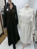 Full-length black crocheted coat and Crochetta , Made in Malta white knitted dress with leg 'o'