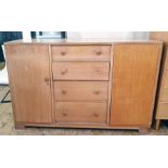 20th century oak sideboard, probably by Gordon Russell, with four central drawers, one bearing