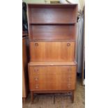 20th century teak lounge unit by Turnidge with open shelves above a secretaire fall base of three
