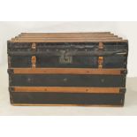 Wooden batoned black leather and studded steamer-type trunk, either end emblazoned with the initials