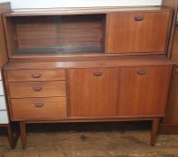 20th century teak lounge unit in the manner of G-Plan, the top section with sliding glass doors