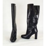 Pair of black leather Todd knee-high boots with stack heels, pimple rubber platform soles, barely