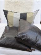 Pair of eelskin brown leather cushions labelled 'AHB', a large silk-covered cushion and a 1970's