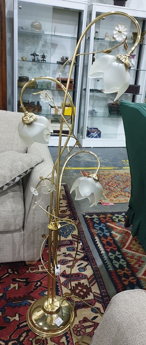 Three-light standard lamp with brass frame and opaque shades as flowerheads