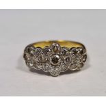 Gold-coloured metal and diamond cluster ring in the form of one large and two smaller flowerheads,