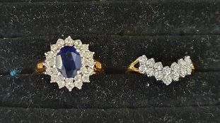 Gold-coloured metal, blue and white stone cluster ring set oval sapphire-coloured stone surrounded