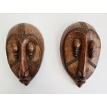 Pair of African masks marked 'Loute'