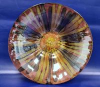 Large modern glass bowl decorated with a pink ground and browns and gold stripes, the reverse with