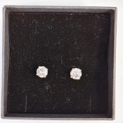 Pair of 18ct white gold diamond stud earrings, each set with a single round brilliant-cut diamond (