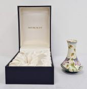 Moorcroft miniature enamel baluster vase, floral decorated on a cream ground, 8cm high, boxed