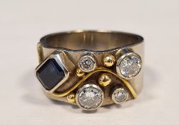 18ct white gold band ring, maker’s mark BMB, Sheffield 2009,  set with an emerald-cut sapphire and