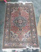 Persian style rug with salmon field, with palmette arabesque and spandrels surrounded by floral