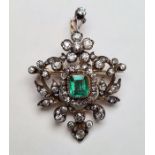 Late 19th/early 20th century gold-coloured and white metal emerald and diamond pendant/brooch, the