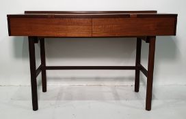Mid century teak dressing table, the rectangular top above two drawers, handles inset into the cut-