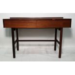 Mid century teak dressing table, the rectangular top above two drawers, handles inset into the cut-