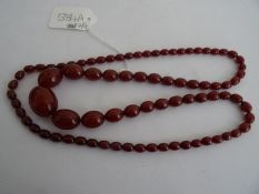 String of red amber-coloured graduated oval beads, the weight is 49.2gCondition Reportweight 49.2