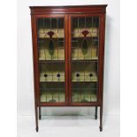 Early 20th century mahogany and satinwood strung display cabinet, with two glazed and leaded doors