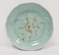 Chinese porcelain shallow dish, celadon glaze with incised waves, 23cm diameter Condition