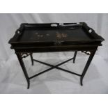 Lacquered tray-top table, the black ground with figural decoration, on stand with X-shaped stretcher