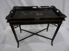 Lacquered tray-top table, the black ground with figural decoration, on stand with X-shaped stretcher