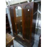 Early 20th century mahogany single mirrored door wardrobe above single drawer, on plinth base, 112cm