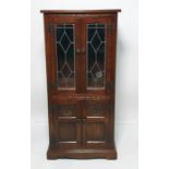 Late 19th/early 20th century narrow dresser with mahogany top, astragal glazed door enclosing