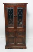 Late 19th/early 20th century narrow dresser with mahogany top, astragal glazed door enclosing