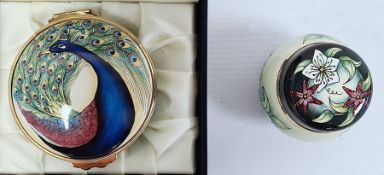 Moorcroft enamel circular trinket box decorated with peacock to lid and peacock feathers to the